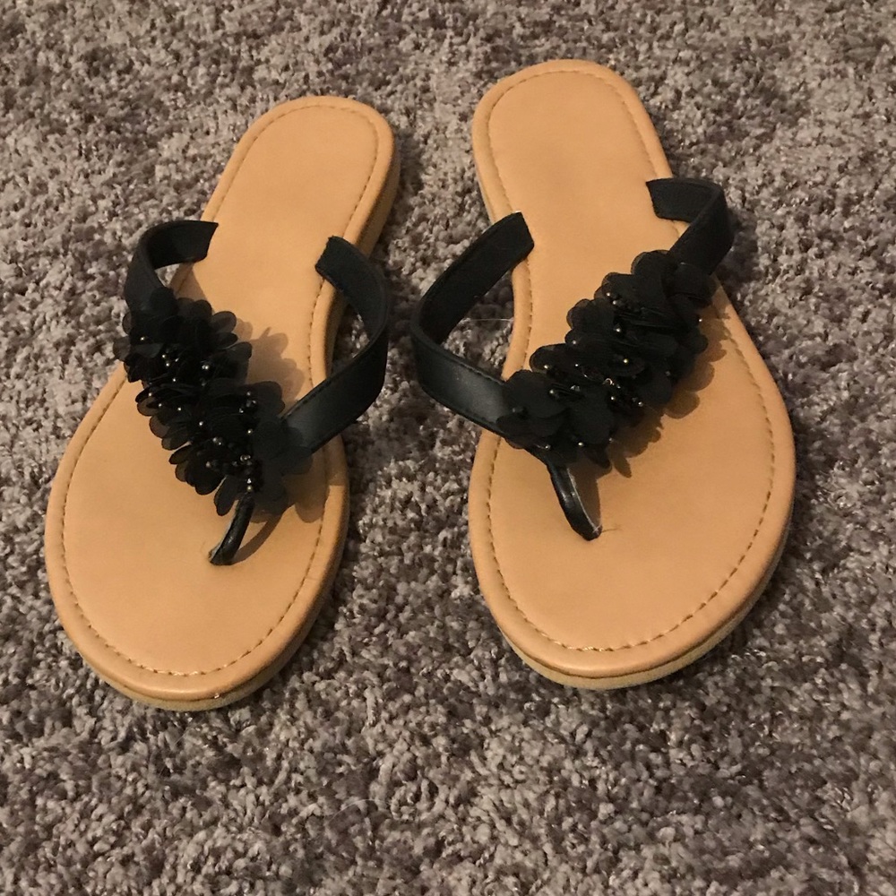 Tan thong sandals with black and gold accents